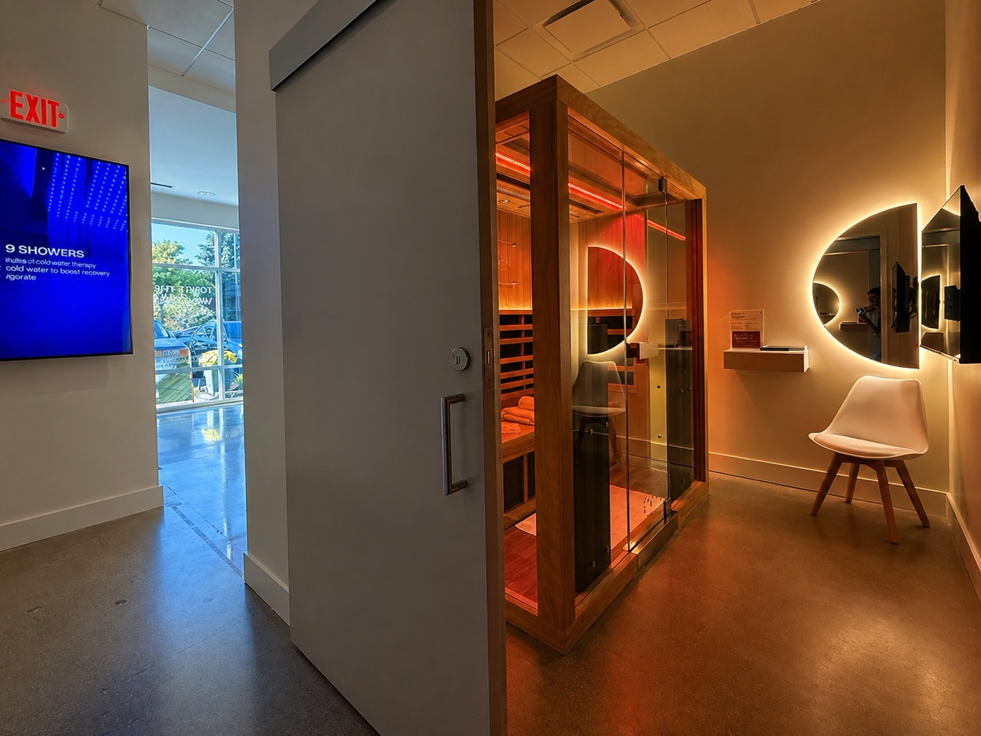 Perspire Sauna Studios franchise suite with an infrared sauna and backlit LED mirror lighting